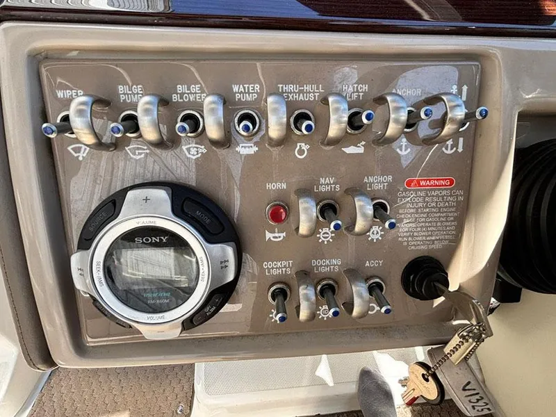 Slide: The Image of Control panel of a 2013 Sea Ray 250 SLX boat with various switches and a Sony stereo. - 25