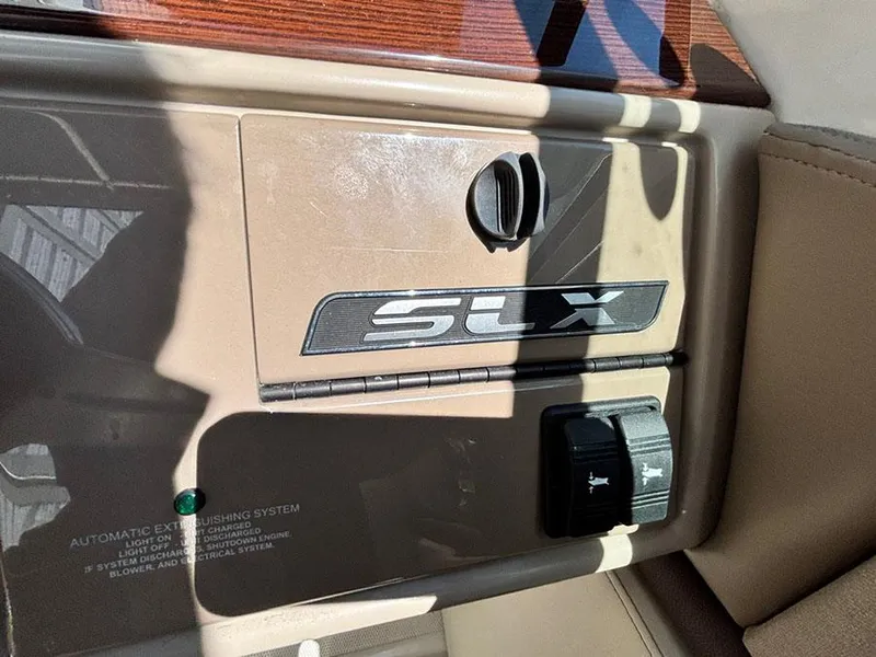 Slide: The Image of 2013 Sea Ray 250 SLX dashboard with SLX logo and control panel. - 26