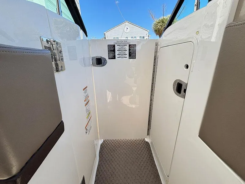 Slide: The Image of Interior view of a 2013 Sea Ray 250 SLX boat, featuring a clean, white cabin area. - 27