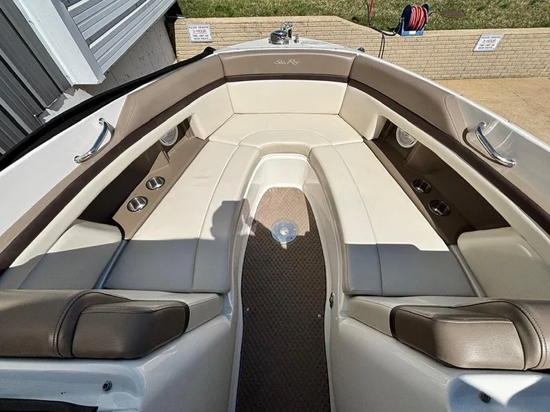 Slide: The Image of 2013 Sea Ray 250 SLX boat interior with beige and brown seating. - 28