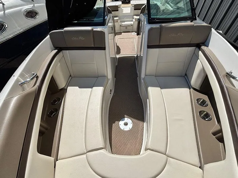 Slide: The Image of 2013 Sea Ray 250 SLX boat interior with beige seating and cup holders. - 30