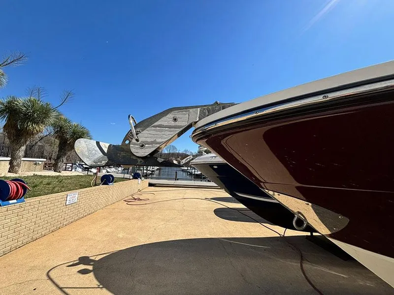 Slide: The Image of 2013 Sea Ray 250 SLX boat docked under clear blue sky. - 4