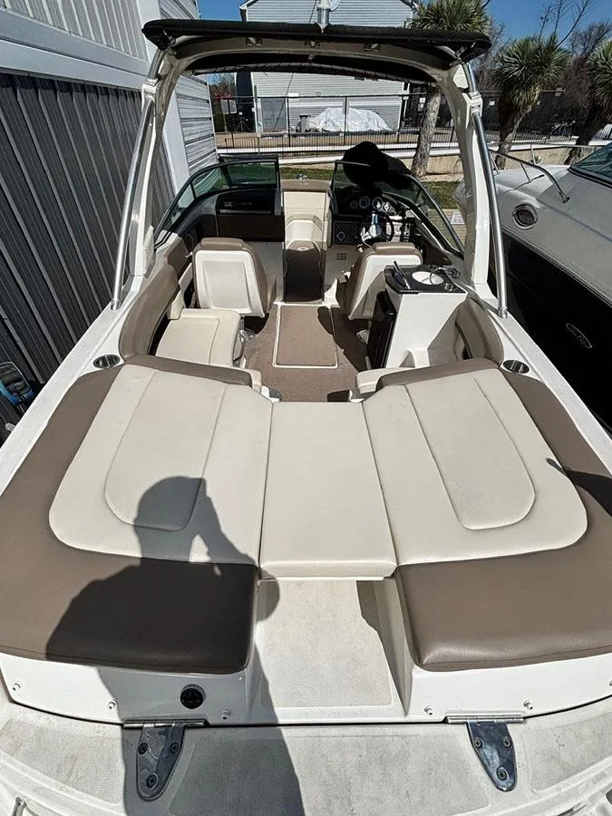 Slide: The Image of 2013 Sea Ray 250 SLX boat interior with beige seating and helm. - 8