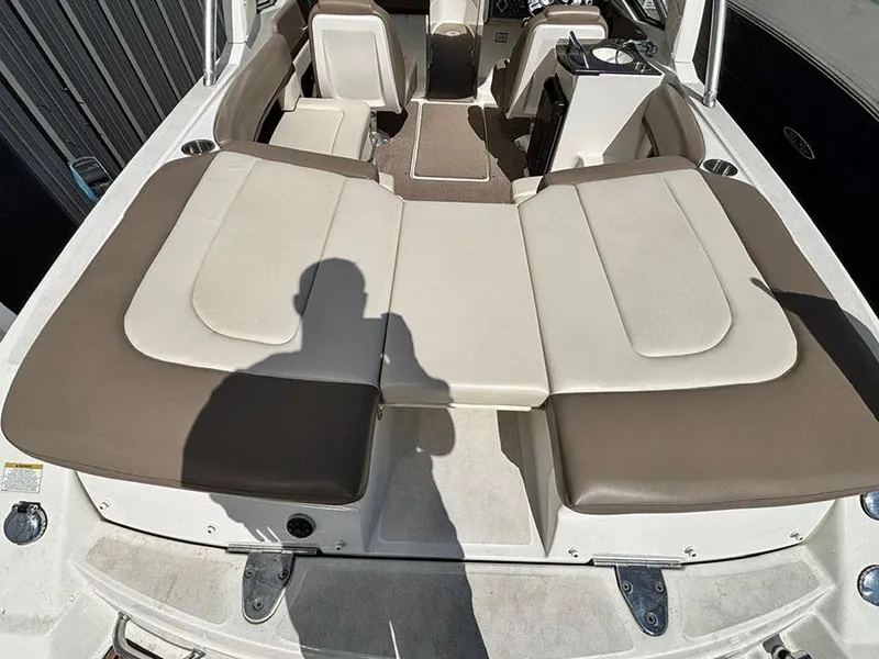 Slide: The Image of 2013 Sea Ray 250 SLX boat interior with beige and brown seating. - 9