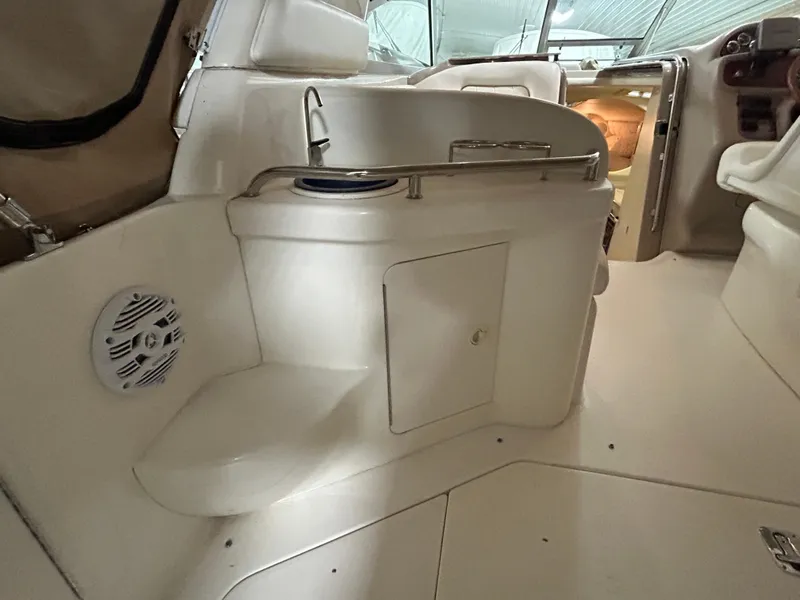 Slide: The Image of Interior of 2000 Sea Ray 290 Sundancer boat, featuring seating and storage. - 12