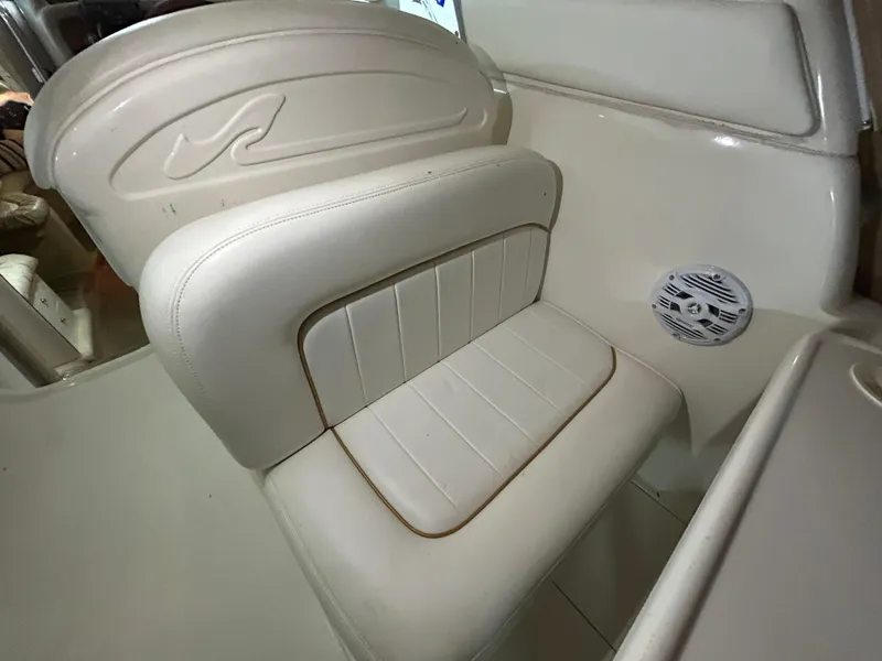 Slide: The Image of White leather seat on 2000 Sea Ray 290 Sundancer boat interior. - 15