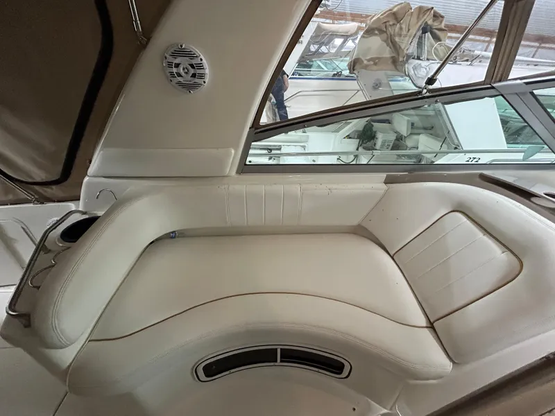 Slide: The Image of Interior seating of 2000 Sea Ray 290 Sundancer boat, featuring white leather upholstery. - 17