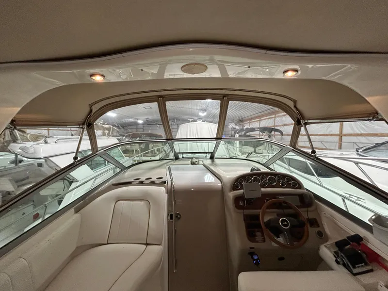 Slide: The Image of Interior view of 2000 Sea Ray 290 Sundancer boat cockpit with steering wheel and seating. - 19