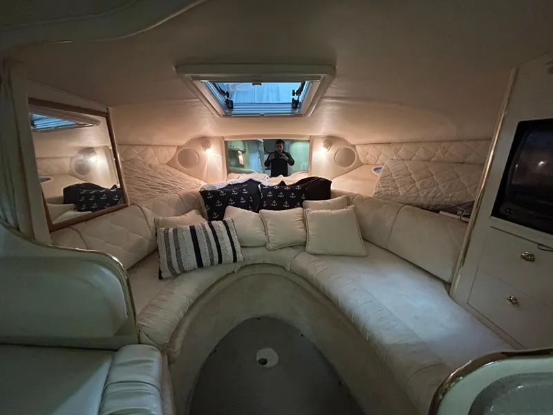 Slide: The Image of Interior of 2000 Sea Ray 290 Sundancer with cozy seating and ambient lighting. - 28