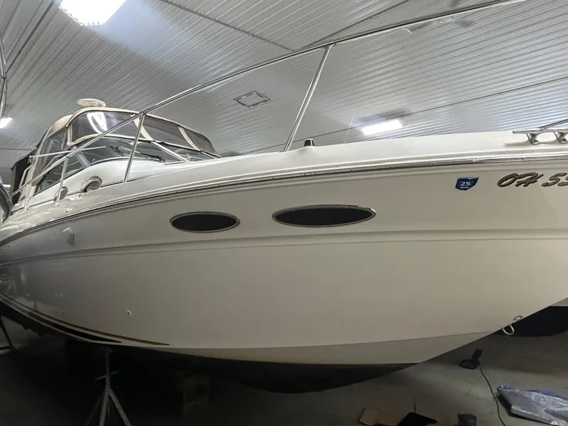 Slide: The Image of 2000 Sea Ray 290 Sundancer boat in indoor storage, side view. - 3