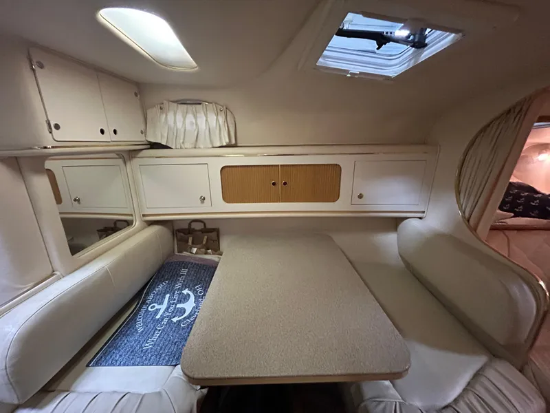 Slide: The Image of Interior cabin of 2000 Sea Ray 290 Sundancer with seating and table. - 34