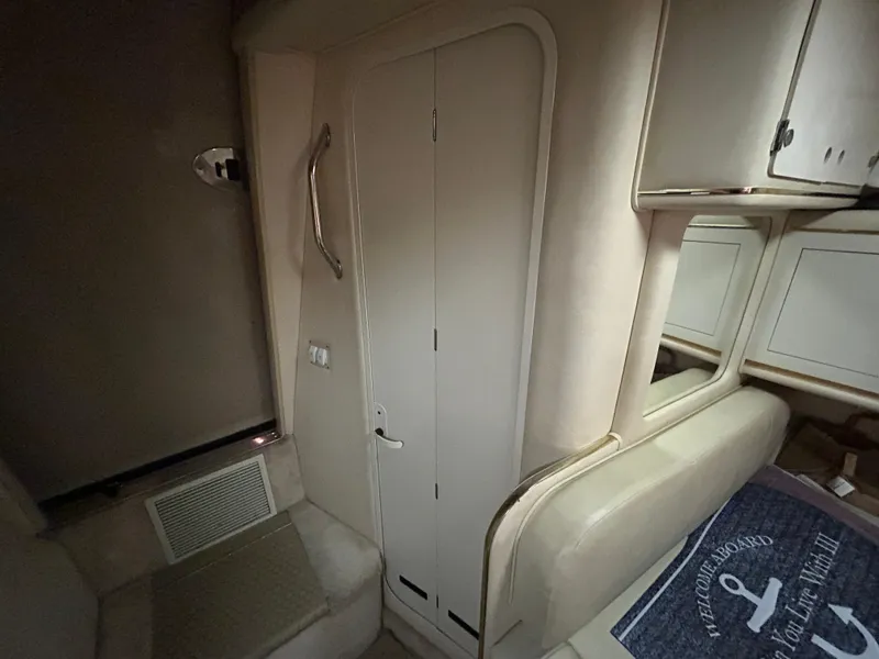 Slide: The Image of Interior cabin of 2000 Sea Ray 290 Sundancer, featuring a door and seating area. - 36
