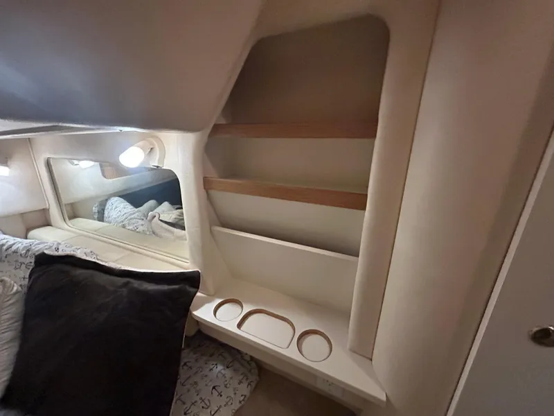 Slide: The Image of Interior cabin of 2000 Sea Ray 290 Sundancer with shelves and bedding. - 39