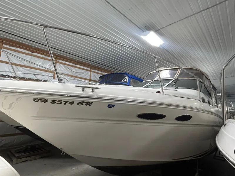 Slide: The Image of 2000 Sea Ray 290 Sundancer boat stored indoors, side view. - 4