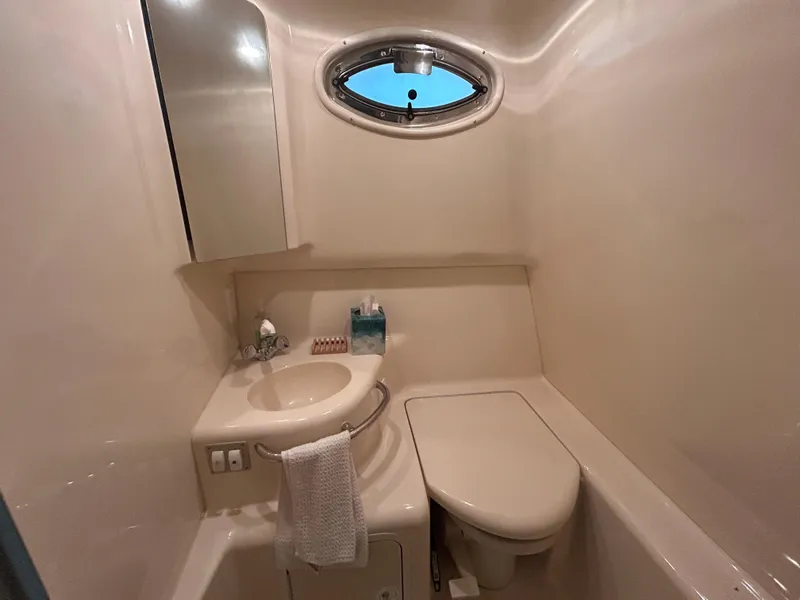 Slide: The Image of Bathroom interior of 2000 Sea Ray 290 Sundancer yacht, featuring sink and toilet. - 42
