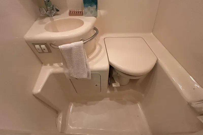 Slide: The Image of 2000 Sea Ray 290 Sundancer bathroom with sink and toilet, compact and functional design. - 43