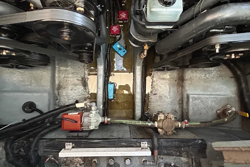 Slide: The Image of Engine compartment of a 2000 Sea Ray 290 Sundancer boat, showing mechanical components. - 47