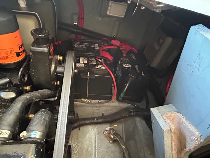Slide: The Image of Engine compartment of a 2000 Sea Ray 290 Sundancer with visible battery and wiring. - 49
