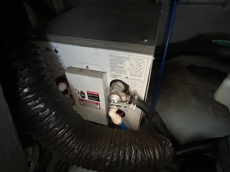 Slide: The Image of Engine compartment of a 2000 Sea Ray 290 Sundancer boat, showing mechanical components. - 51