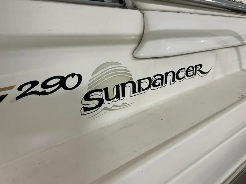 Slide: The Image of Sea Ray 290 Sundancer 2000 model boat logo on white hull. - 7