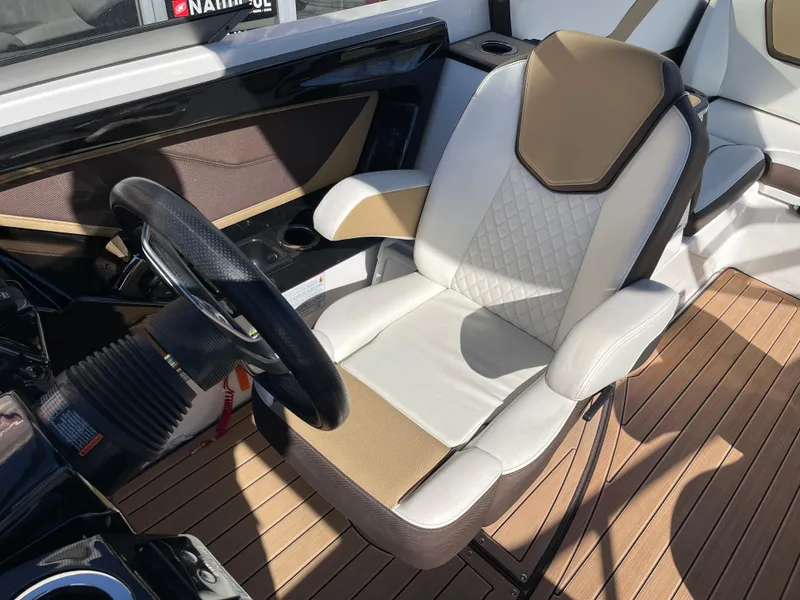 Slide: The Image of 2021 Yamaha Boats 252SE interior with luxury seating and steering wheel. - 10