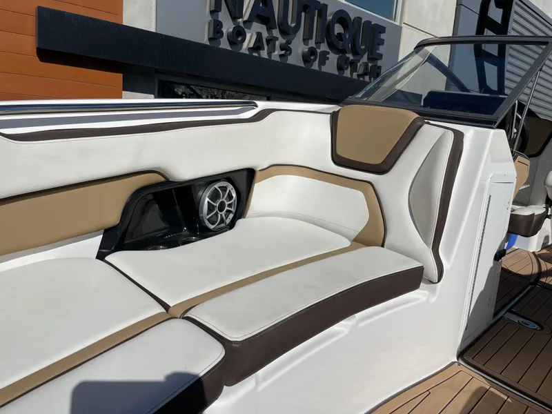 Slide: The Image of 2021 Yamaha Boats 252SE interior with cushioned seating and speaker detail. - 14