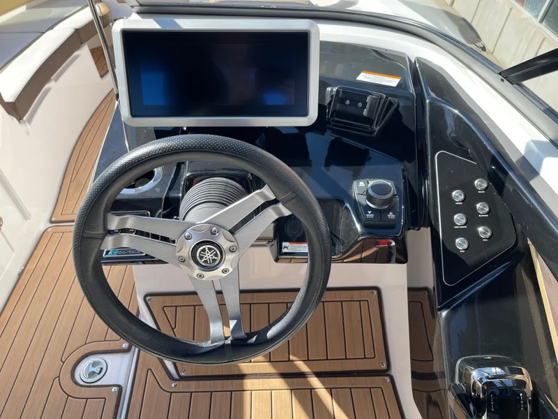 Slide: The Image of 2021 Yamaha Boats 252SE dashboard with steering wheel and touchscreen display. - 15