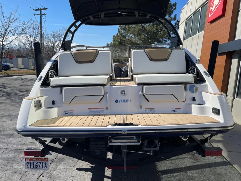 Slide: The Image of 2021 Yamaha Boats 252SE, rear view, showcasing seating and swim platform. - 2