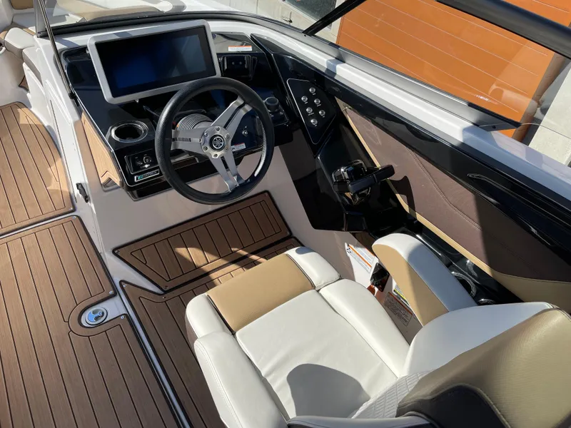 Slide: The Image of 2021 Yamaha Boats 252SE cockpit with steering wheel, touchscreen display, and luxurious seating. - 9