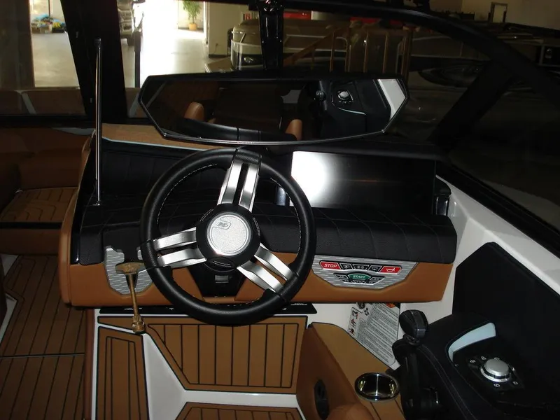 Slide: The Image of 2024 Nautique Super Air Nautique G23 dashboard with steering wheel and controls. - 12