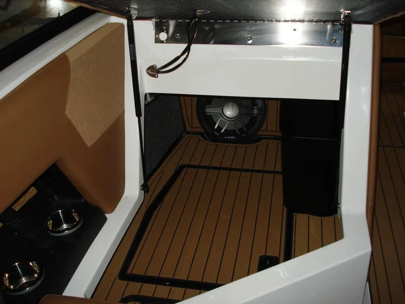 Slide: The Image of 2024 Nautique Super Air Nautique G23 interior with speaker and wood flooring. - 21