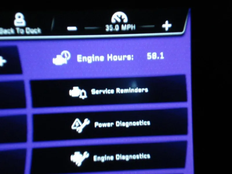 Slide: The Image of Dashboard display of 2024 Nautique Super Air Nautique G23 showing engine hours and diagnostics. - 24