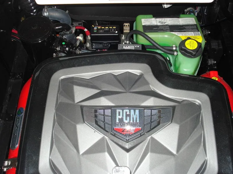 Slide: The Image of 2024 Nautique Super Air Nautique G23 engine compartment with PCM cover and components. - 25