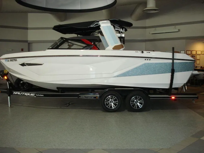 Slide: The Image of 2024 Nautique Super Air Nautique G23 boat on trailer in showroom. - 3