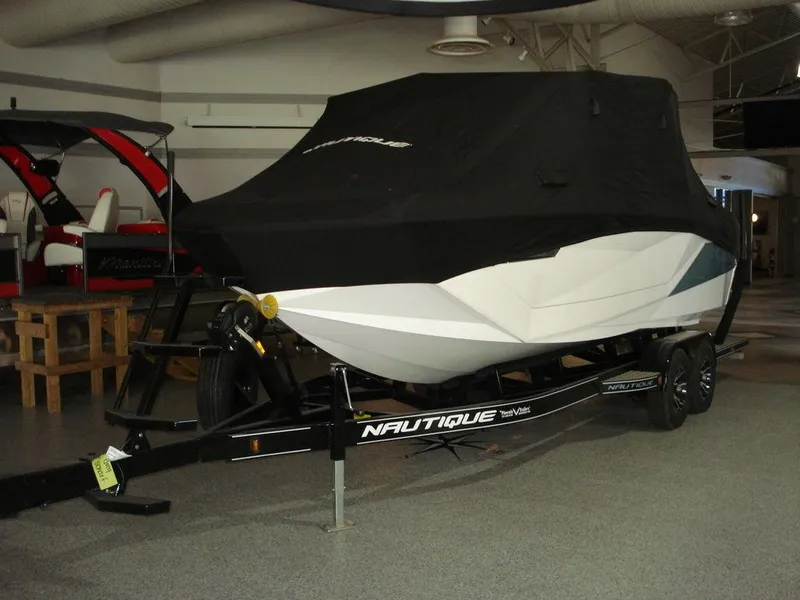 Slide: The Image of 2024 Nautique Super Air Nautique G23 boat covered on trailer in showroom. - 4