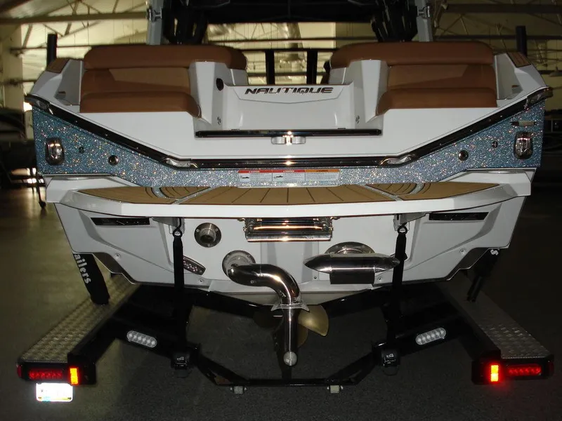 Slide: The Image of 2024 Nautique Super Air Nautique G23 boat rear view on trailer. - 6