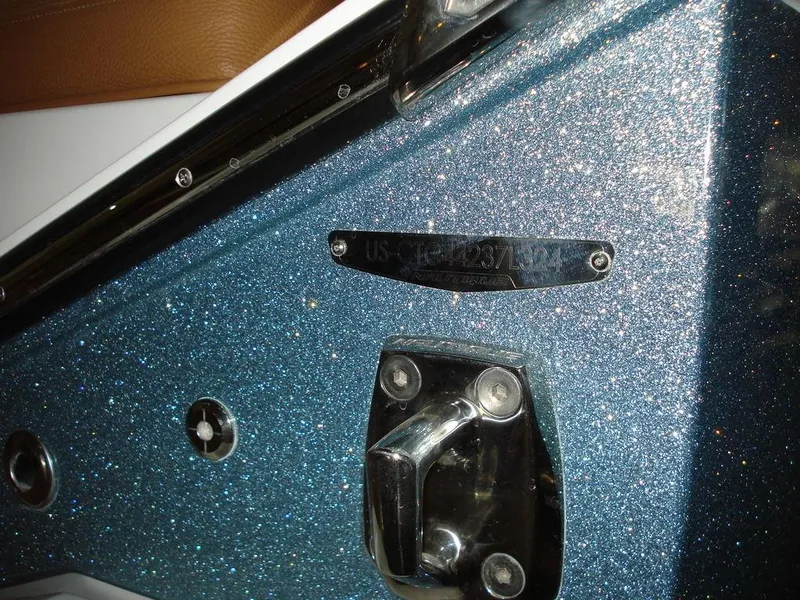 Slide: The Image of 2024 Nautique Super Air Nautique G23 boat with metallic blue finish and hardware details. - 7