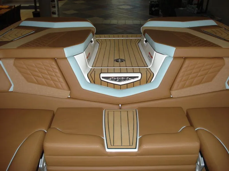 Slide: The Image of 2024 Nautique Super Air Nautique G23 interior with tan and white upholstery, featuring sleek design elements. - 9
