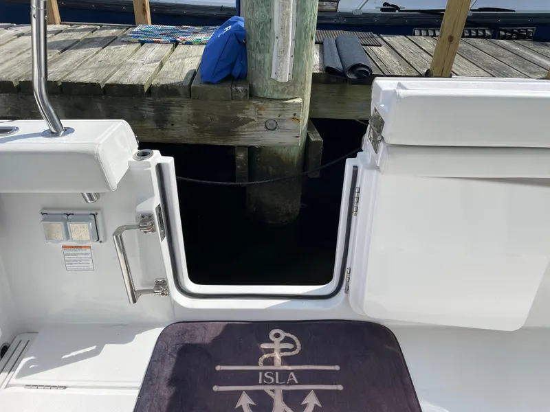 Slide: The Image of 2022 Bertram 39 CC boat with open transom door, docked by wooden pier. - 10