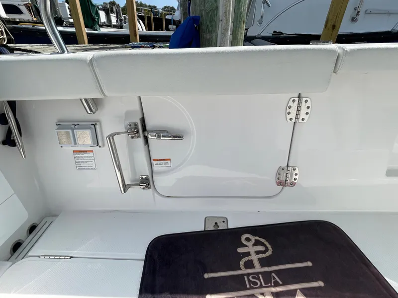 Slide: The Image of 2022 Bertram 39 CC boat interior with seating and nautical-themed mat. - 11