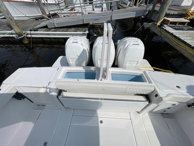 Slide: The Image of 2022 Bertram 39 CC boat with dual outboard engines at a marina dock. - 13