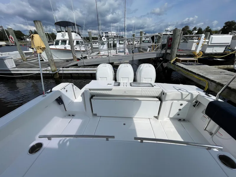 Slide: The Image of 2022 Bertram 39 CC boat docked at marina, showcasing spacious deck and seating area. - 15