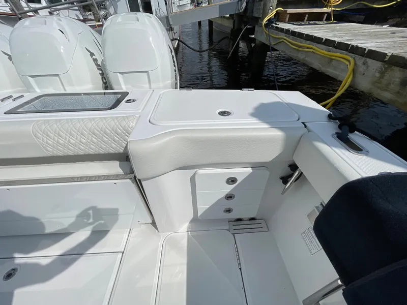 Slide: The Image of 2022 Bertram 39 CC boat interior with white seating and storage compartments. - 16