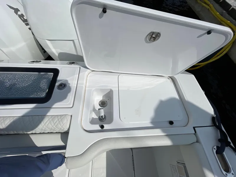 Slide: The Image of 2022 Bertram 39 CC boat deck with open storage compartment and seating area. - 17