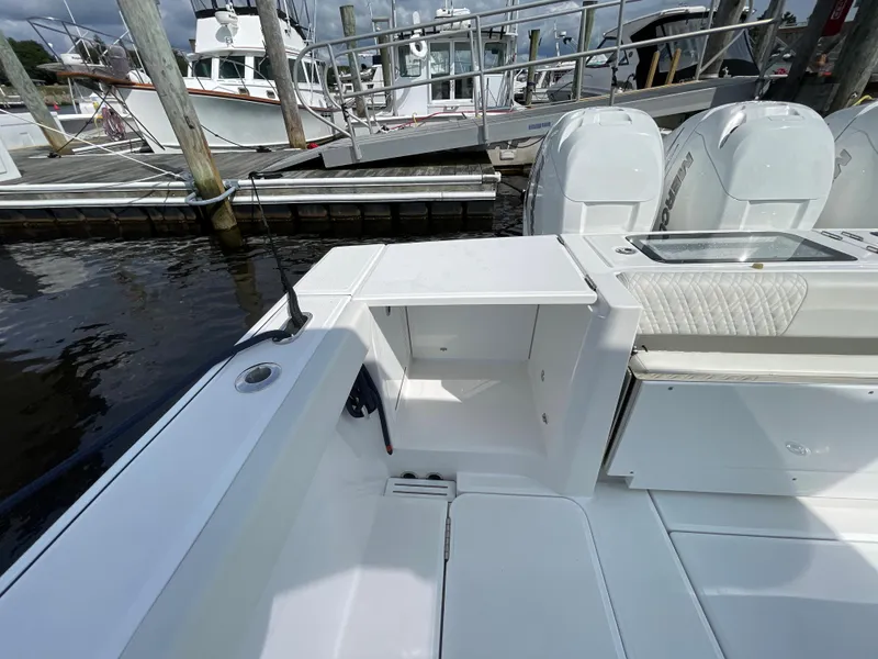 Slide: The Image of 2022 Bertram 39 CC boat interior at dock, featuring storage and seating area. - 18