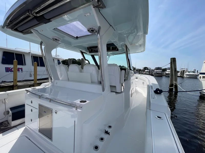 Slide: The Image of 2022 Bertram 39 CC boat docked at marina, showcasing sleek design and spacious deck. - 23