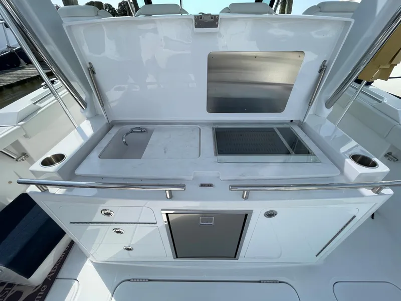 Slide: The Image of 2022 Bertram 39 CC boat galley with sink, grill, and storage compartments. - 25