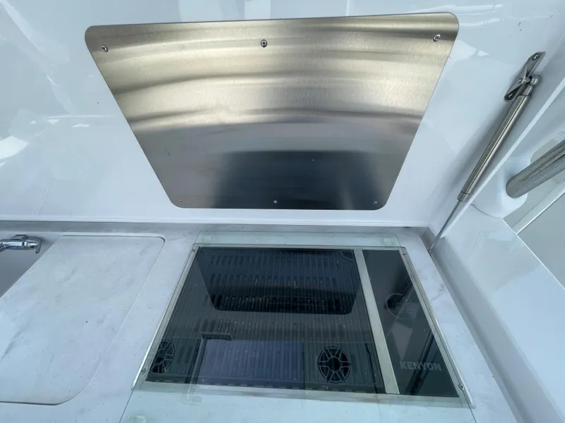 Slide: The Image of 2022 Bertram 39 CC boat interior with stainless steel panel and Kenyon grill. - 26