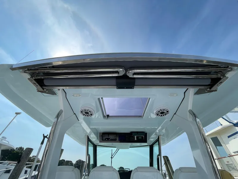 Slide: The Image of 2022 Bertram 39 CC boat interior with skylight and speakers, viewed from below. - 35