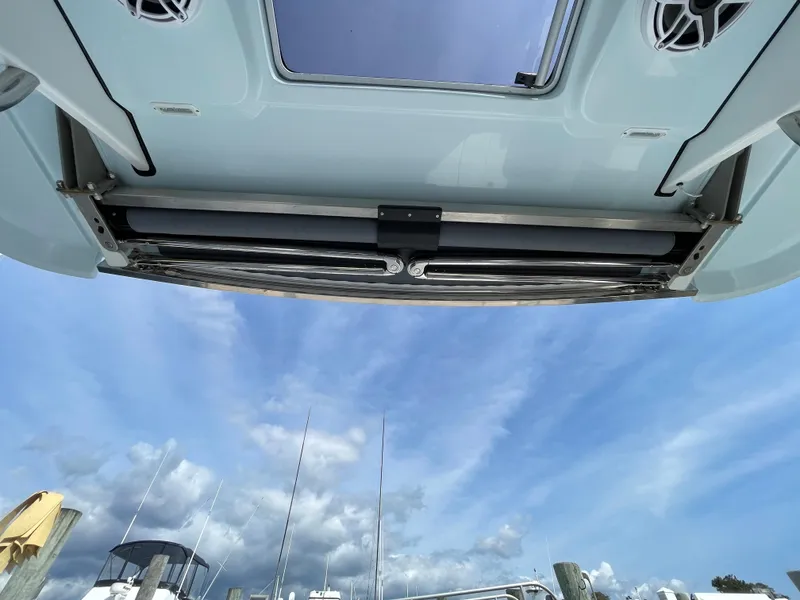 Slide: The Image of 2022 Bertram 39 CC boat roof view with speakers, under a blue sky. - 38